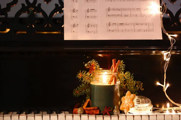 Burning Candle Christmas Treats Decor Glowing Lights Piano Keys Closeup — Stock Photo, Image