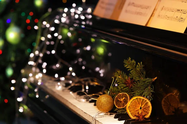 Fir Branch Christmas Ball Orange Slices Glowing Lights Black Piano — Stock Photo, Image