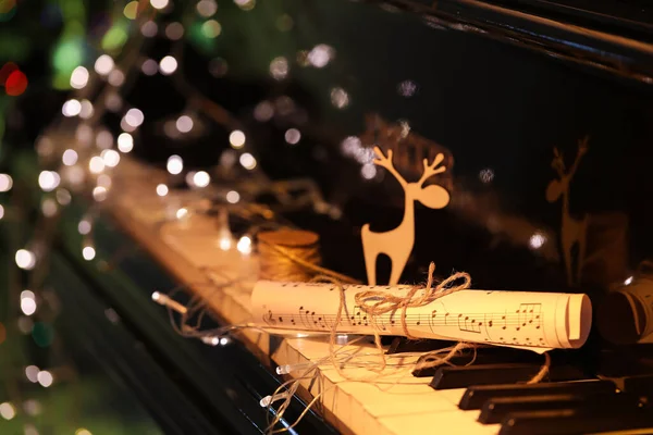 Rolled Music Sheet Glowing Lights Black Piano Closeup — Stock Photo, Image