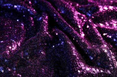 Arkaplan olarak pulları olan mor kumaş