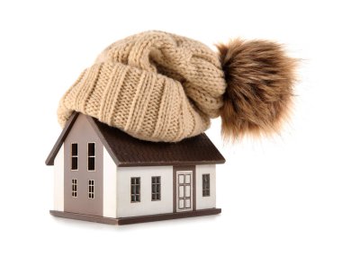 House model with hat on white background. Heating concept clipart