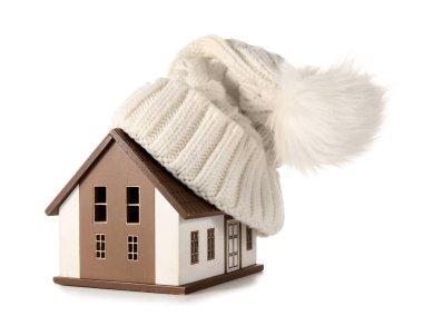 Beyaz arka planda şapkası olan ev modeli. Isıtma kavramı