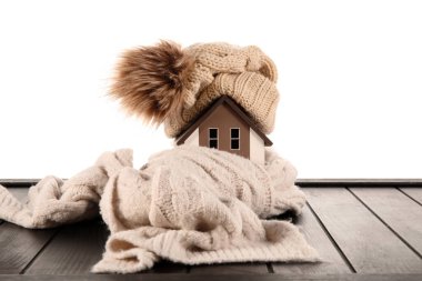 Beyaz arka planda şapka ve eşarplı ev modeli. Isıtma kavramı