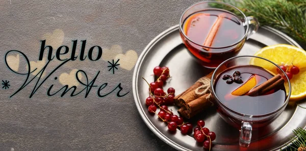 Banner with tasty mulled wine and text HELLO WINTER on grunge background