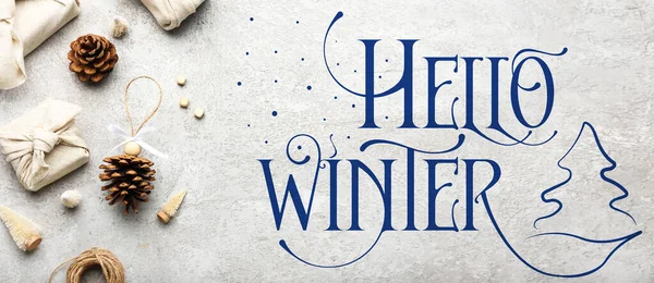 Banner with beautiful gifts and text HELLO WINTER on grunge background
