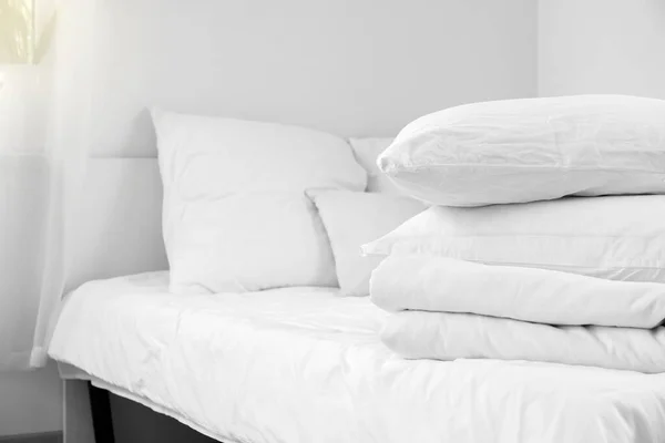Stack of pillows and blanket on comfortable bed