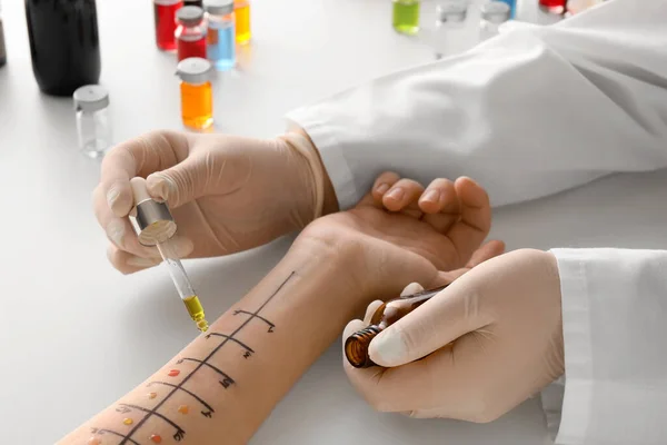 Doctor making allergy skin test on patient\'s hand in clinic, closeup