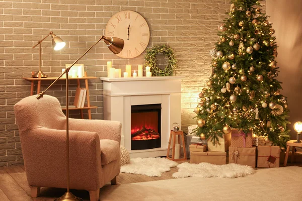 Interior of dark living room with Christmas wreath, fireplace and fir tree