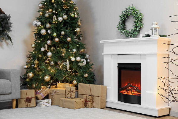 Interior of living room with Christmas wreath, fireplace and fir tree