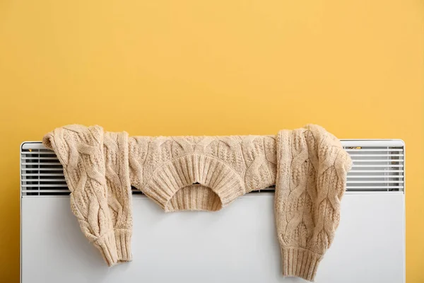 Warm Sweater Drying Electric Radiator Yellow Wall — Stock Photo, Image