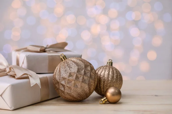 Shiny Christmas Balls Gifts Table Blurred Lights — Stock Photo, Image