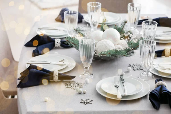 Stylish table setting for Christmas dinner in room