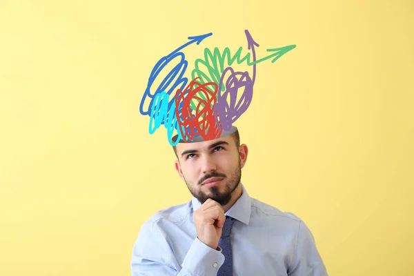 Thoughtful Young Businessman Many Arrows Head Yellow Background — Stock Photo, Image