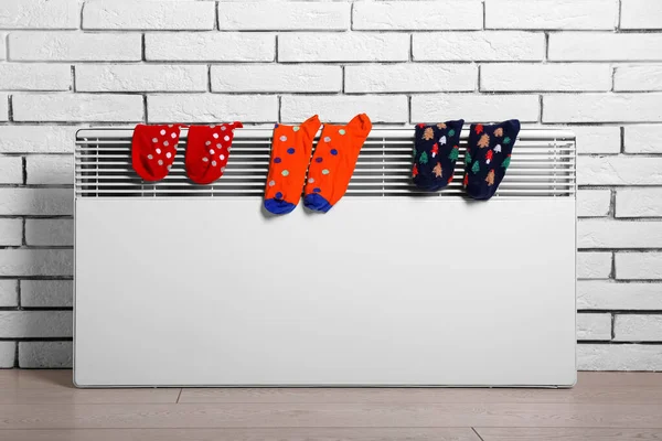 Warm Socks Drying Electric Radiator White Brick Wall — Stock Photo, Image
