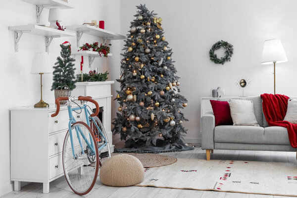 Interior of living room with Christmas trees and bicycle