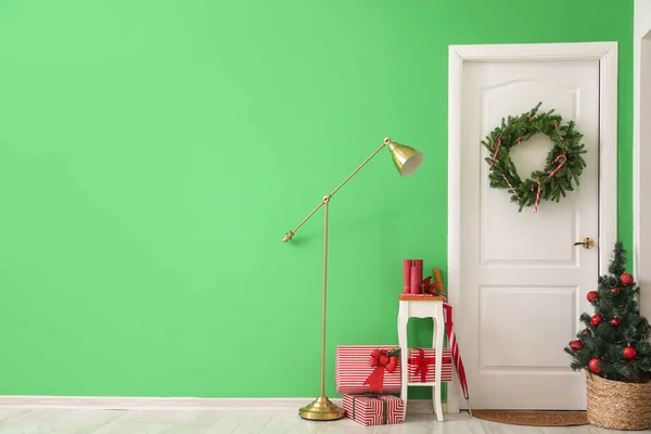 stock image Interior of hall with white door, Christmas wreath and fir tree