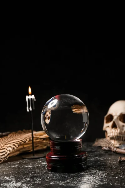 Crystal ball and magic attributes of fortune teller on table