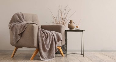 Yumuşak koltuk, masa ve ekoseli modern oturma odası.