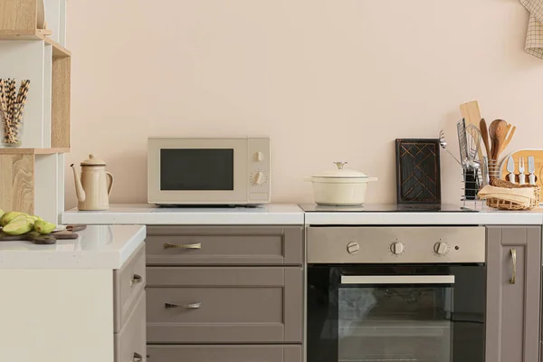 stock image Interior of modern light kitchen with microwave oven