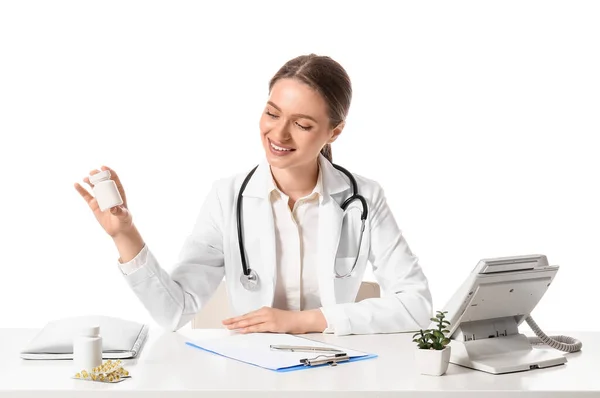 Médico Femenino Con Vitaminas Sentado Mesa Sobre Fondo Blanco —  Fotos de Stock