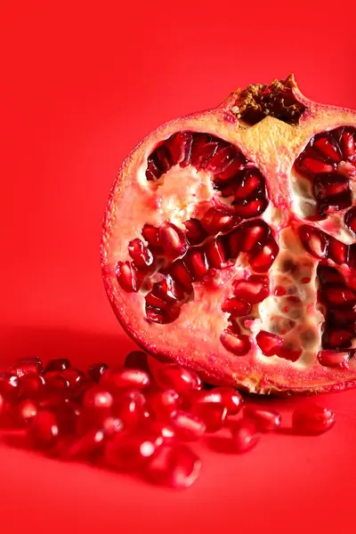 Ripe Pomegranate Red Background Closeup — Stock Photo, Image