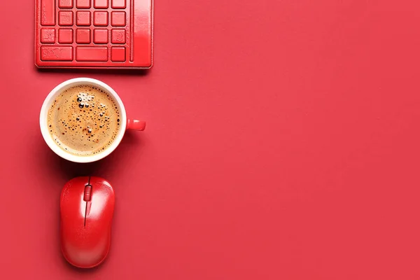 Computer keyboard, cup of coffee and mouse on red background