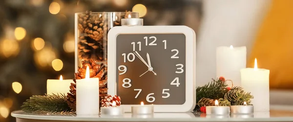 Uhr Mit Brennenden Kerzen Und Weihnachtsdekoration Auf Dem Tisch Zimmer — Stockfoto