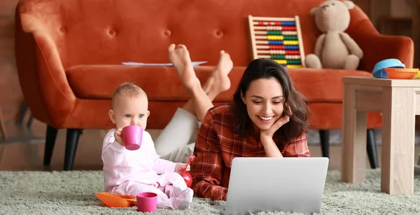 Working mother with her baby at home