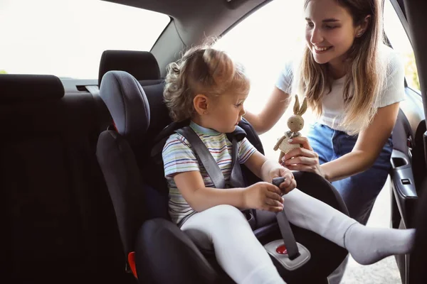 Mother Her Little Daughter Toy Buckled Car Safety Seat — Stock Photo, Image