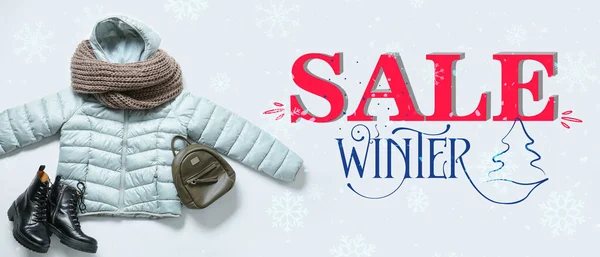 Banner for winter sale with warm clothes on white background