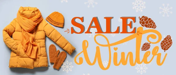 Banner for winter sale with warm clothes on grey background