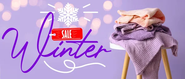 Banner for winter sale with warm sweaters on lilac background