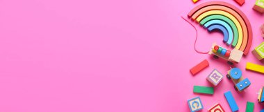 Pembe arka planda, metin için alanı olan çocuk oyuncakları seti