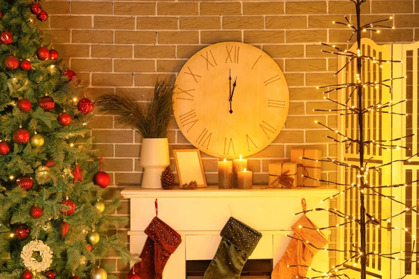 Big clock in interior of dark living room decorated for Christmas