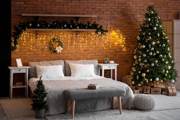 卧室的内部 有圣诞树 冷杉树枝和灿烂的灯光 — 图库照片