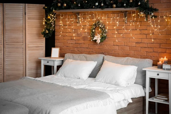 卧室的内部 有圣诞花环和明亮的灯光 — 图库照片