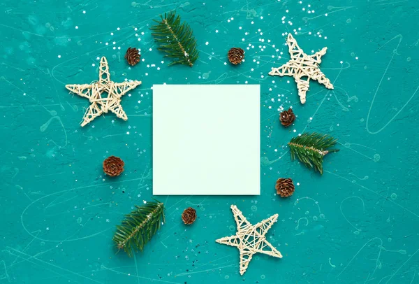 stock image Composition with blank card, Christmas decorations, cones and fir branches on color background