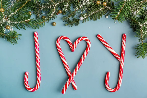 Word Joy Made Candy Canes Fir Branches Color Background — Stock Photo, Image