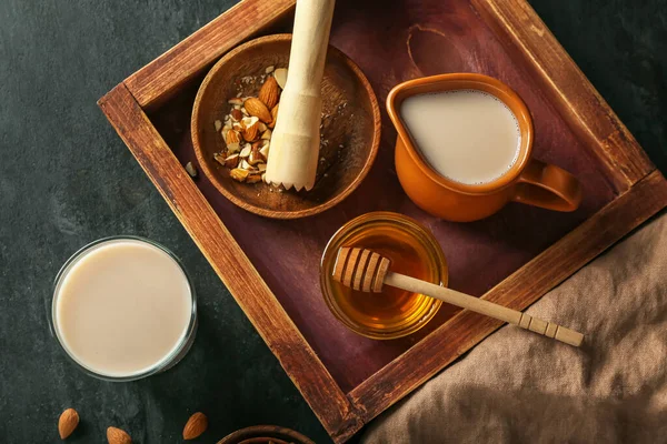 Wooden Board Jug Almond Milk Honey Nuts Dark Background Closeup — Stock Photo, Image