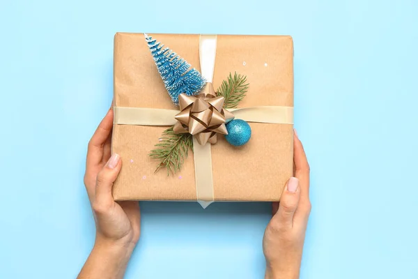 青の背景に美しいクリスマスの贈り物を持つ女性 — ストック写真