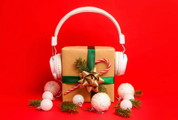Headphones Christmas Gift Fir Branches Balls Red Background — Stock Photo, Image