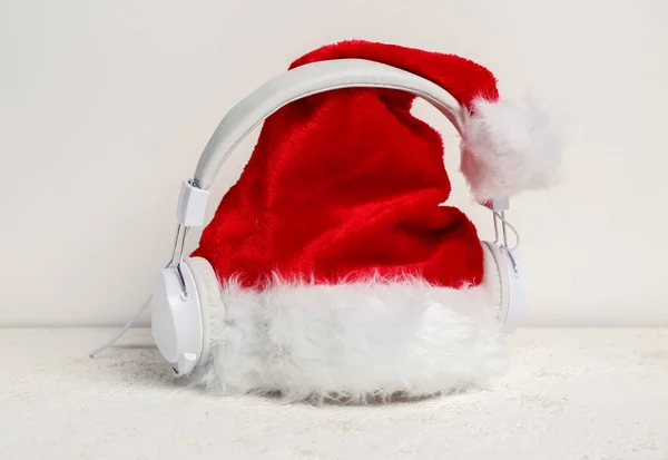 Arka Planda Noel Baba Şapkası Olan Kulaklıklar — Stok fotoğraf