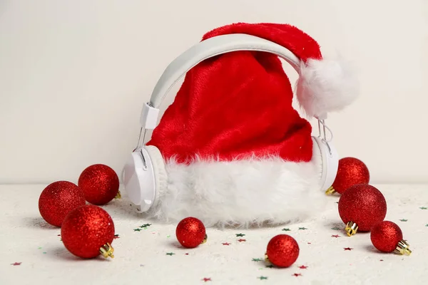 Słuchawki Kapeluszem Santa Kulki Świąteczne Lekkim Tle — Zdjęcie stockowe