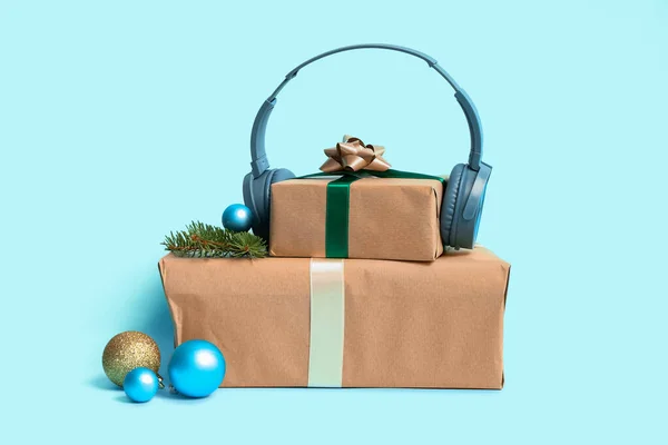 Headphones Christmas Gifts Fir Branches Balls Blue Background — Stock Photo, Image