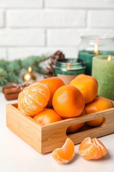 stock image Wooden box with fresh ripe tangerines on table