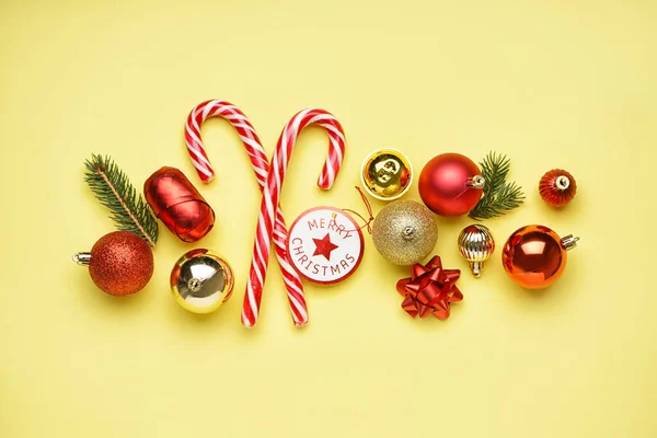 Candy Canes Christmas Balls Bells Fir Branches Yellow Background — Stock Photo, Image