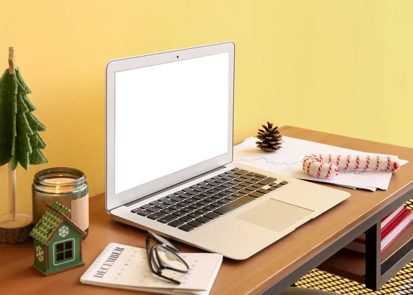 Laptop Christmas Toys Candle Table Yellow Wall — Stock Photo, Image