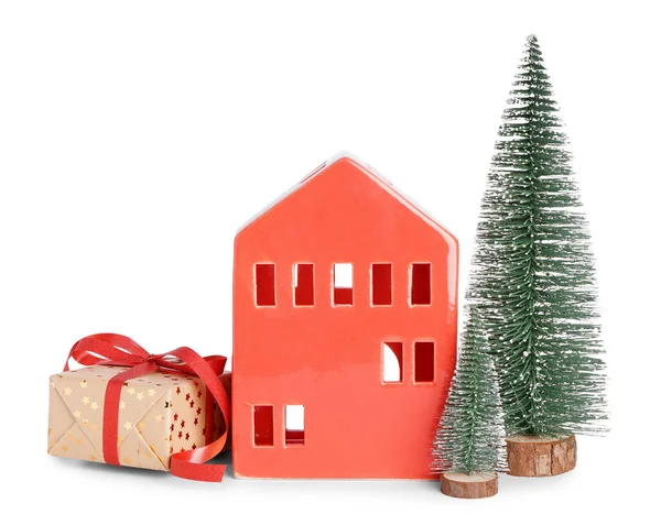 stock image Red candle holder in shape of house with Christmas trees and gift on white background