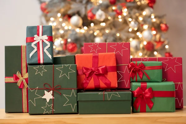 Gift Boxes Table Blurred Christmas Tree — Stock Photo, Image