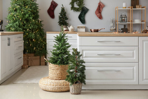Small Christmas trees with pouf in interior of kitchen